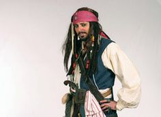 a man dressed up in pirate costume posing for the camera