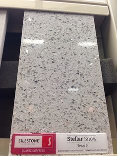 a store shelf filled with lots of different types of counter top materials and labels on it