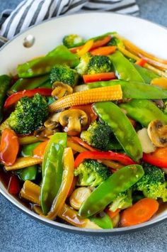 stir fry vegetables are mixed together in a wok on the stove top, ready to be eaten