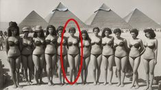 a group of women in bathing suits standing next to each other with pyramids in the background