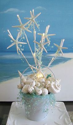 a cake decorated with seashells and starfish