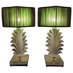 a pair of lamps with green shades on them