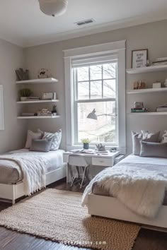 two twin beds in a bedroom with white walls and shelves on the wall above them