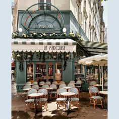 an outdoor cafe with tables and chairs outside