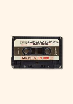 an old fashioned cassette with the words running up that hill on it's side