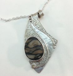 This beautiful pendant is completely hand-crafted from precious metal clay (Art Clay Silver). Every pendant from my studio is unique because each is crafted using textures created by me--not molds or stamps. No two will even be identical and you will never see anyone else wearing an identical piece. The pendant measures 2-1/4 inch long and 1-1/4 inch wide and is finished with a dark patina. It features a champagne color cubic zirconia, and is set with a marble stone. It comes complete with an 18-inch sterling silver plated chain so it is ready to wear from moment you receive it, and is packaged in a box suitable for gift giving. This item will ship within 1-3 days. It will ship USPS Priority. Metal Clay Art, Art Clay Silver, Clay Silver, Agate Pendant Necklace, Metal Clay Jewelry, Precious Metal Clay, Jewelry Metal, Art Clay, Marble Stone