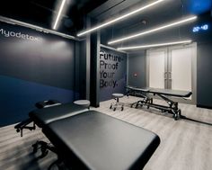 an empty room with tables and chairs in the center, next to a sign that says future proof your body