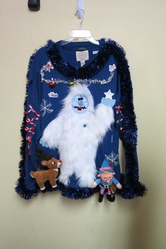 a child's ugly sweater hanging on a wall