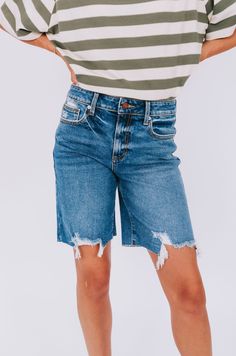 Get ready for a summer to remember with these playful high rise denim shorts. The rips and fraying at the bottom add a touch of edge and uniqueness, making these shorts a staple for any summer wardrobe. (Plus, they'll keep you looking cool while staying cool!) Details High rise fit Denim Rips/fraying at the bottom Sizing Approximate measurements: SIZE LENGTH/INSEAM WAIST Small 18/11" 30" Medium 19/11" 32" Large 19/11" 34" Fabric has stretchModel is 5’8 wearing small Material 97% Cotton 2% Elaste Medium Wash Shorts With Frayed Hem, Summer Cotton Jean Shorts With Frayed Hem, Summer Jean Shorts With Frayed Hem, Summer Shorts With Frayed Hem, Summer Cutoff Bermuda Shorts With Built-in Shorts, Distressed High-waisted Jean Shorts In Relaxed Fit, Ripped Medium Wash Cotton Shorts, Distressed High-waisted Jean Shorts Relaxed Fit, Distressed Relaxed Fit High-waisted Jean Shorts