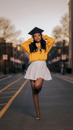 a woman in a yellow sweater and white skirt is walking down the street with her hands on her head