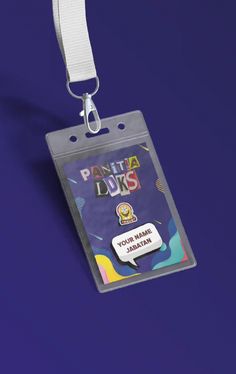 an id badge with a lanyard hanging from it's side on a purple background