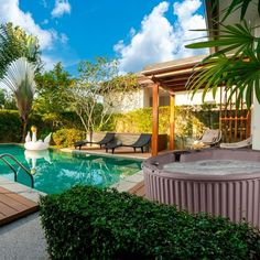 an outdoor hot tub next to a swimming pool