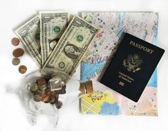 a passport, money and other items on a white surface with a map in the background