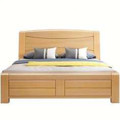 a bed with two pillows on top of it and drawers underneath the headboard is made of wood