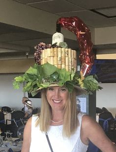 a woman wearing a hat made out of wine corks and other things on her head