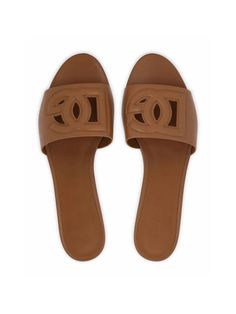 Step into effortless style with these leather slides. The embossed logo and cut-out detailing add a touch of sophistication, while the almond toe and branded insole keep you comfortable all day long. Complete with a flat rubber sole, these slides are the perfect combination of fashion and function. Light brown calf leather Embossed logo to the front Cut-out detailing Almond toe Branded insole Flat rubber sole Dg Logo, Leather Cap, Dolce E Gabbana, Boot Pumps, Mens Gloves, Footwear Design Women, Leather Slides, Brown Sandals, Beach Tote Bags