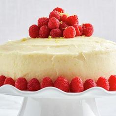 a lemon raspberry cake on a white platter with the words, lemon - raspberry cake