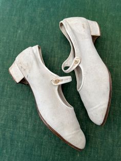 When I say sport shoes, sports for women in the 1920s was still an endeavour on dressed for.  Golf was played in skirts with shirts, ties and cardigans; tennis was played in beautiful drop waist dresses; victorian women mountaineers still wore full skirts and corsetry.  These shoes might have been worn on the tennis court or for a walk.  They have a low 1 inch/25mm squat heel.  They are made from a canvas.  They have a roundish toe and a single strap with a button closure.  There is a fine trim Vintage Fitted Closed Toe Dance Shoes, Vintage Fitted Dance Shoes With Low Heel, Fitted Vintage Dance Shoes With Low Heel, Classic Closed Toe Dance Shoes For Spring, Vintage Dance Shoes With Leather Sole And Round Toe, Vintage Closed Toe Dance Shoes With Leather Sole, Skirts With Shirts, Dresses Victorian, Shoes Mary Jane