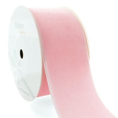 a roll of pink satin ribbon on a white background