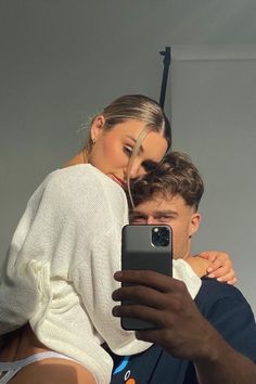 a man taking a selfie with his girlfriend