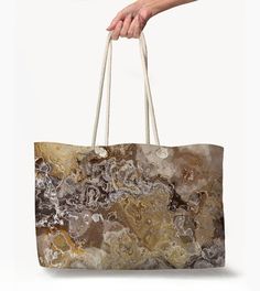 My Oversized Rope Handle Tote is perfect for a day at the beach, a weekend getaway or out on the town. The wide-mouthed, durable bag with my abstract art holds a generous amount of your gear and is easily held by the thick rope handles. * All Over Print * Flat T-Bottom * Cream Colored 27" Rope Handles  * Metal Grommets * Cream Sheeting Interior Lining * 24 in wide, 13 in tall, 5 in deep They are individually printed with my abstract art using the most advanced digital printing technology. Dye-sublimation printing yields vivid and permanent images that are embedded in the fabric, rather than printed on the surface. Made of 100% Spun polyester with a 50% cotton, 50% polyester lining, this tote retains its shape and doesn't wrinkle. Sand Colored Beach Bag For Vacation Travel, Summer Beach Bag In Sand Color For Travel, Sand Colored Travel Bags For Beach Season, Beach Season Vacation Bag In Sand Color, Beachy Rectangular Beach Bag For Travel, Summer Beach Weekender Bag In Rectangular Shape, Rectangular Summer Weekender Bag For Beach, Summer Rectangular Weekender Bag For Beach, Large Capacity Summer Weekender Bag For Beach