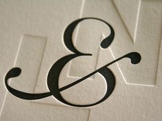 the letter b is made up of black and white paper with an arrow on it