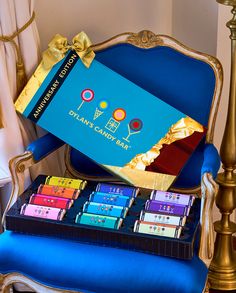 an assortment of candy bars sitting on top of a blue chair