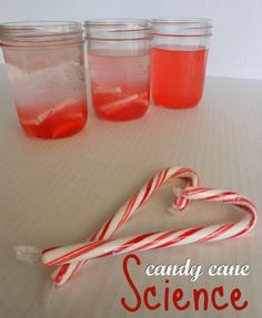 some candy canes are sitting next to jars with liquid in them that says candy cane science