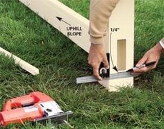 a man is measuring the height of a bench with a pair of scissors and tape