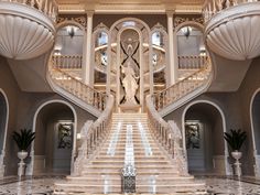 an elaborate staircase in the middle of a large building