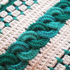 closeup of crocheted green and white blanket