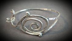 Customized in size, this Sterling Silver bracelet has been handcrafted with a swirl design, making a great addition to everyone's jewelry box. Elegant Spiral Bracelet As Gift, Handmade Spiral Bangle As Gift, Handmade Spiral Bangle Gift, Elegant Spiral Bracelet For Gift, Unique Swirl Jewelry As A Gift, Handmade Swirl Jewelry With A Modern Twist, Elegant Spiral Sterling Silver Bracelets, Elegant Spiral Cuff Bracelet As Gift, Elegant Spiral Cuff Bracelet Gift