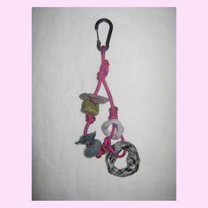 a pink lanyard with several charms hanging from it's end and a black leash attached to it