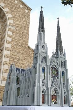 a large model of a cathedral on display in front of a building