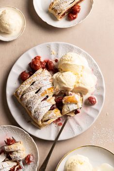 two plates with desserts and ice cream on them, one has a fork in it