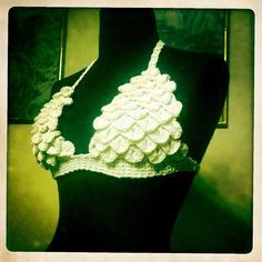 a white crocheted halter top on a mannequin