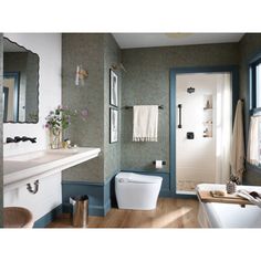 a bathroom with green walls and white fixtures