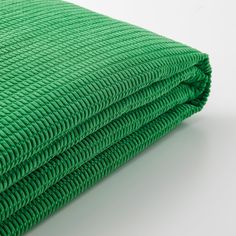 a stack of green towels folded on top of each other