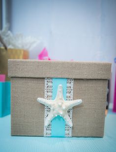 a white starfish sitting on top of a piece of paper next to a box