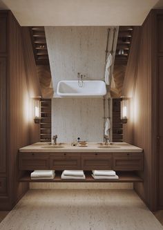 a large bathroom with two sinks and towels on the counter top, along with wooden cabinets