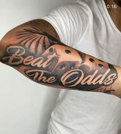 a man with a tattoo on his arm that says, beat the odds and an elephant