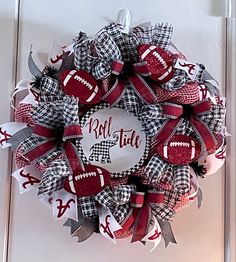 a red and white football wreath hanging on the front door