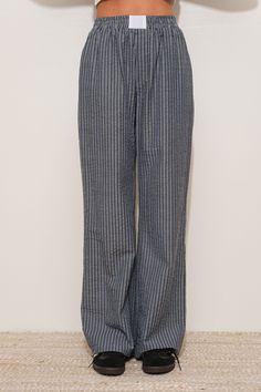 Navy/black striped boxer pant. Has a baggy/ wide leg fit and sits high waisted. Model is wearing a small. Striped Wide Leg Trousers With Elastic Waistband, Casual Pinstripe Wide Leg Bottoms, Striped Wide Leg Pants With Elastic Waistband For Work, Casual Pinstripe Wide-leg Bottoms, Striped Straight Leg Bottoms With Elastic Waistband, Striped Bottoms With Elastic Waistband For Daywear, Casual Wide Leg Pants For Work, Pinstripe Straight Leg Bottoms With Relaxed Fit, Pinstripe Relaxed Fit Straight Leg Bottoms