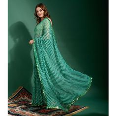 Green colored saree is made from georgette fabric which is highlighted with beautiful striped print and mirror work as shown. comes along unstitched zari brocade blouse piece which you can customise as per your design/style. Occasion - You can wear this saree for festivals and functions. Note:- The actual product may differ slightly in color and design from the one illustrated in the images when compared with computer or mobile screen. Measurements: Saree : Chiffon : 5.5 Mtrs Blouse : Chiffon : 0.8 Mtr Material: Chiffon Stitch Type: Unstitched Country of Origin: India Care Guide: Dry Clean Green Georgette Saree With Mirror Work, Festive Green Chiffon Saree, Green Chiffon Saree With Dupatta, Traditional Green Chiffon Saree, Bollywood Style Chiffon Dupatta With Printed Border, Bollywood Chiffon Dupatta With Printed Border, Green Georgette Dupatta With Printed Border, Bollywood Green Pre-draped Saree With Printed Border, Green Chiffon Saree With Unstitched Blouse