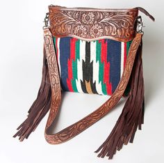 Hand-woven wool saddle blanket with genuine leather and long-lasting, resilient zipper closures.

Interchangeable strap with heavy duty lobster clasp

15''L x 14.5''H x 2.5''W

Fringe 15.5''

Strap stands at 22.5'' above bag

*Concealed Carry*

Westernthorn.com Western Saddle Blanket Purse, Fashion Week 2024, Western Handbags, Large Crossbody Bags, Saddle Blanket, Horse Supplies, Tan Cowhide, Saddle Pad, Dog Products