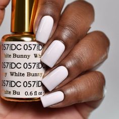 DND DC Duo 100% Pure Gel Pack: 1 Gel Lacquer .5 oz + 1 Lacquer .5oz Matching ColorIt lasts to 21 days. LED and UV cured. Made in USA. Instructions: Gently remove the shine from nail bed with 180/240 buffer and clean the oil/dirt from nail bed. Apply 1st thin layer of Daisy soak-off gel color. Be sure to seal the free edge foe each step Cure under UV Lamp for 2 mins or LED for 60 seconds Apply 2nd layer Daisy Soak-Off Gel Color. Cure under UV Lamp or LED lamp with the same time as step 3 Apply Da Best Uv Gel Nail Polish Brand, Dnd White Nail Polish, Dnd 057 White Bunny, White Bunny Nail Polish Dnd, White Bunny Nail Polish, Dc Gel Polish Colors, Dnd Gel Nails, Nail Polish Application, Dnd Nail Polish