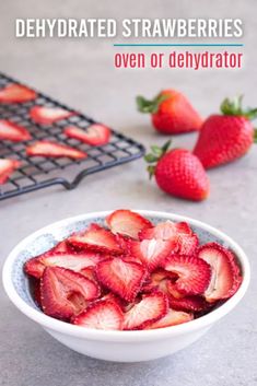 a bowl filled with sliced strawberries on top of a counter