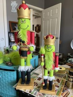 two green and red nutcrackers on top of a table