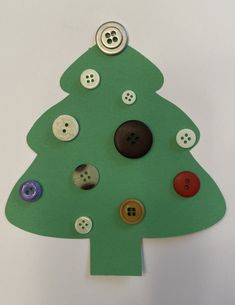 a paper christmas tree with buttons on it