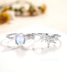 an opal stone ring sits on top of a piece of paper